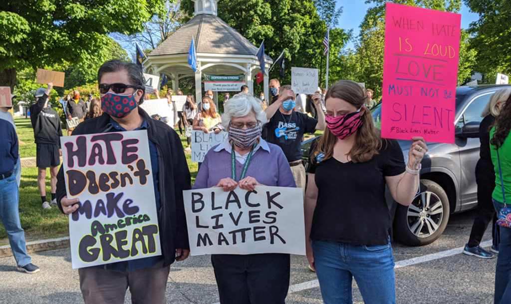 Irfan, Mary Jo, and Amy R with anti-racism signs.